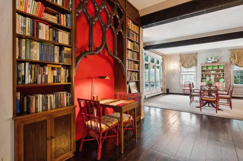 a living room with furniture and a book shelf