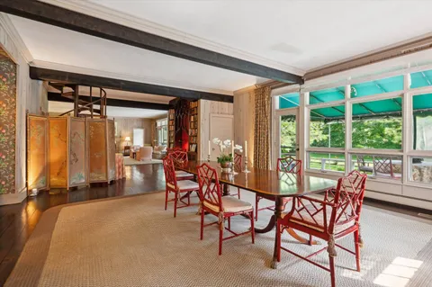 a dining room with furniture and a window