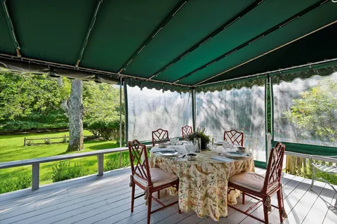 a view of a porch with furniture and garden