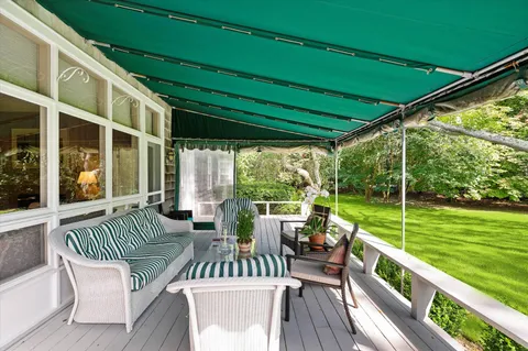 a view of a two chairs in the balcony