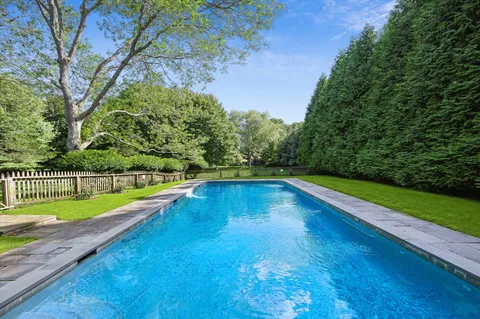 a view of swimming pool with a yard