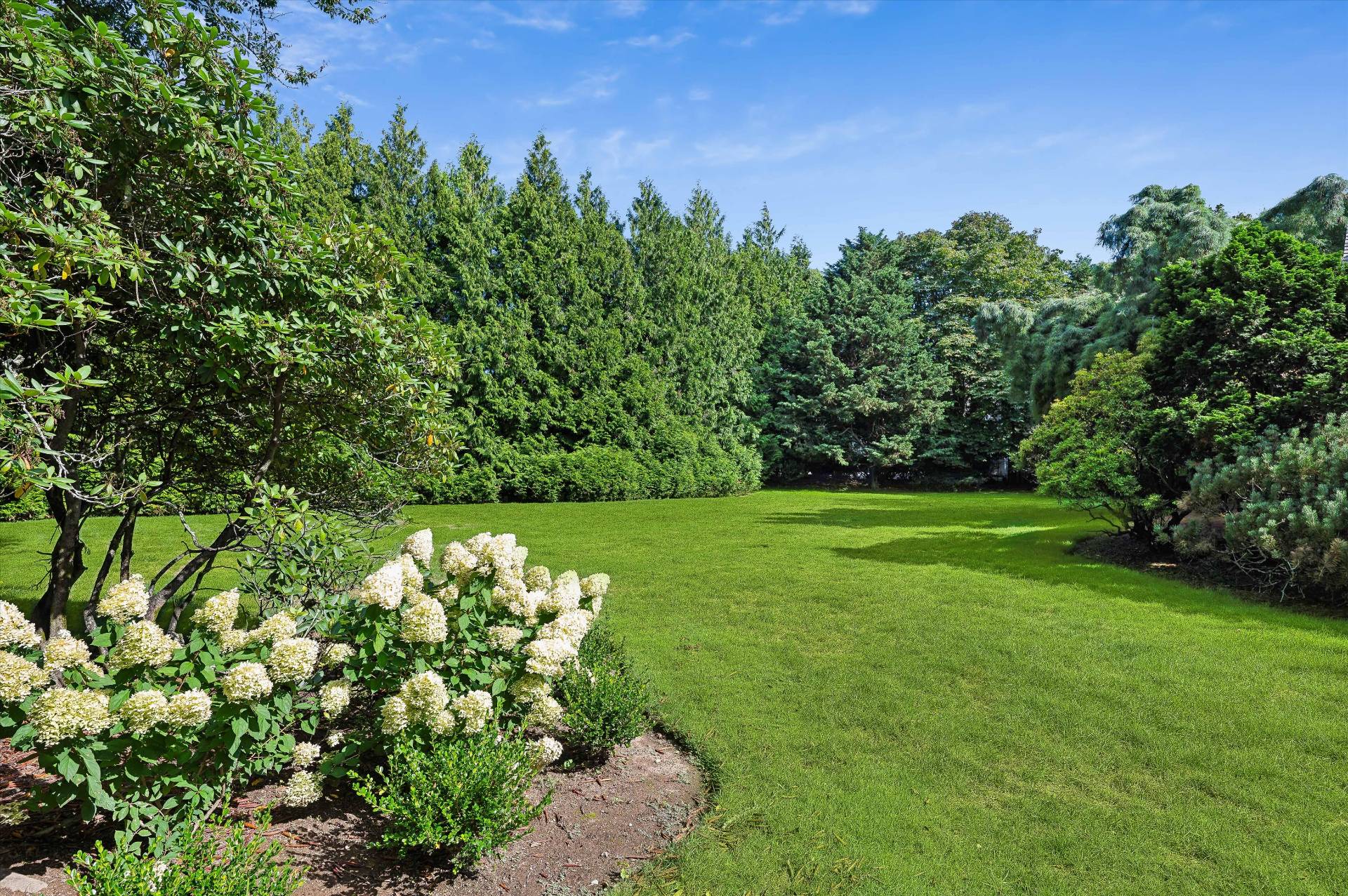 32 Ox Pasture Road Southampton, NY 11968 - Photo 3 of 25 a view of a garden with large trees