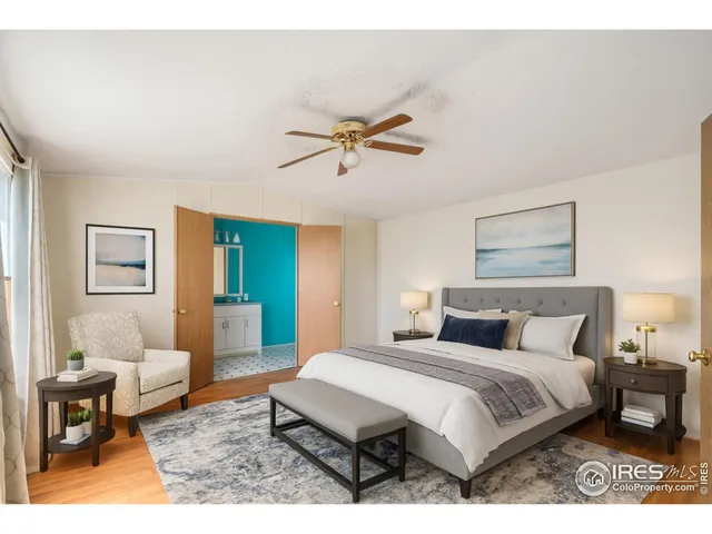 a bedroom with a bed a table and chair