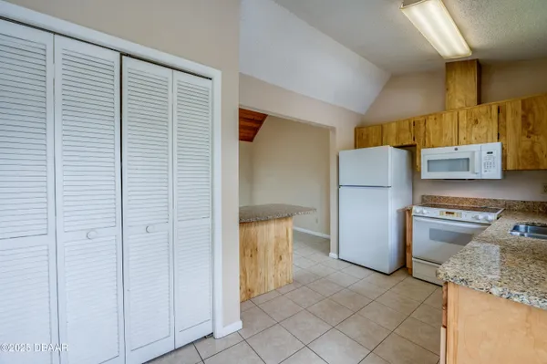 a kitchen with a refrigerator and a stove