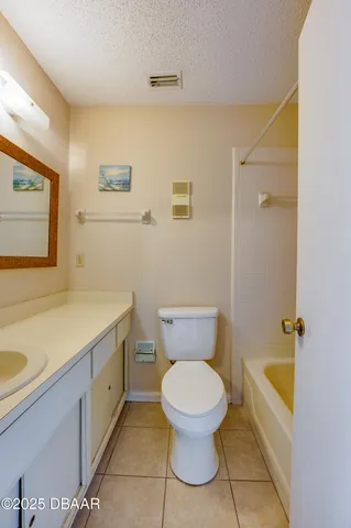 a white toilet sitting next to a bathroom sink