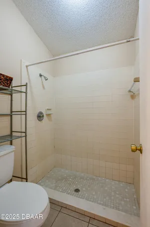 a white toilet sitting next to a bath tub and shower