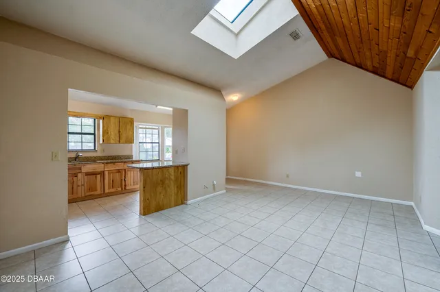 an empty room with a kitchen