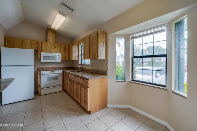 a kitchen with a stove a sink and a refrigerator