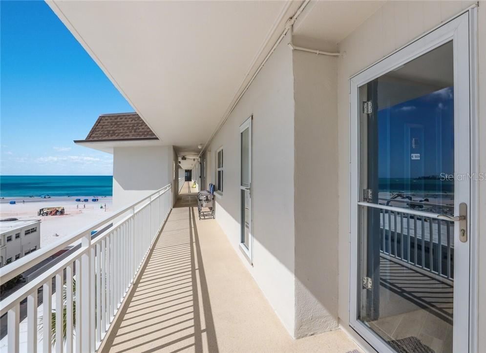 2110 Benjamin Franklin Drive, Unit 503SEA Sarasota, FL 34236 - Photo 1 of 29 a view of a hallway with a dining room and stairs