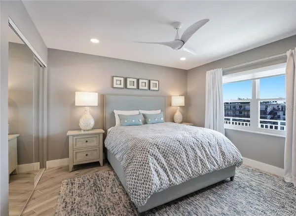 a bedroom with a large bed and a flat tv screen on dresser