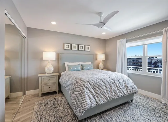 a bedroom with a large bed and a flat tv screen on dresser