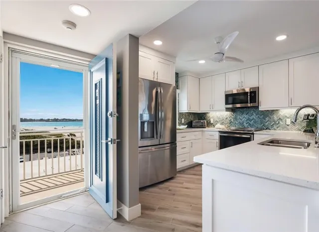 a kitchen with a refrigerator and a stove top oven