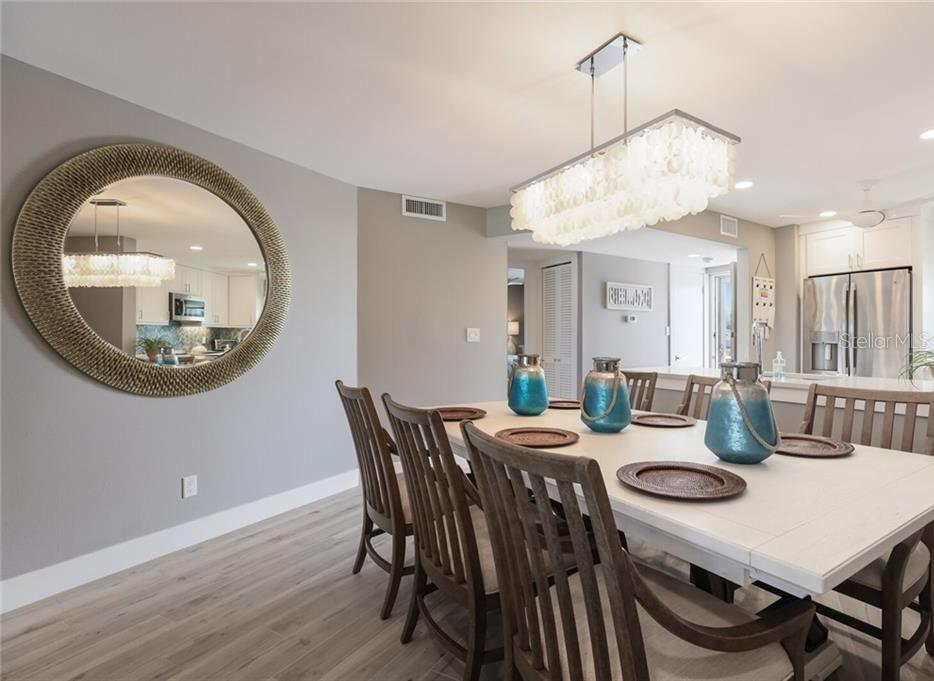 2110 Benjamin Franklin Drive, Unit 503SEA Sarasota, FL 34236 - Photo 5 of 29 a view of a dining room with furniture and wooden floor