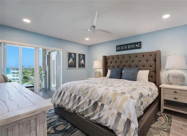 a bedroom with a large bed and a large window