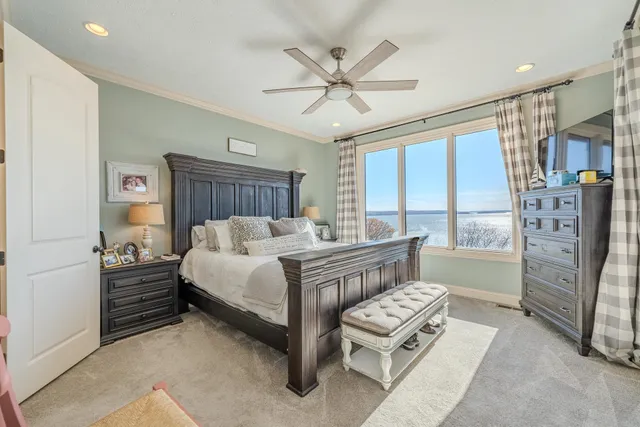 a bedroom with a large bed and a large window