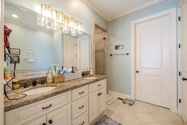 a bathroom with a sink vanity granite shower and a mirror