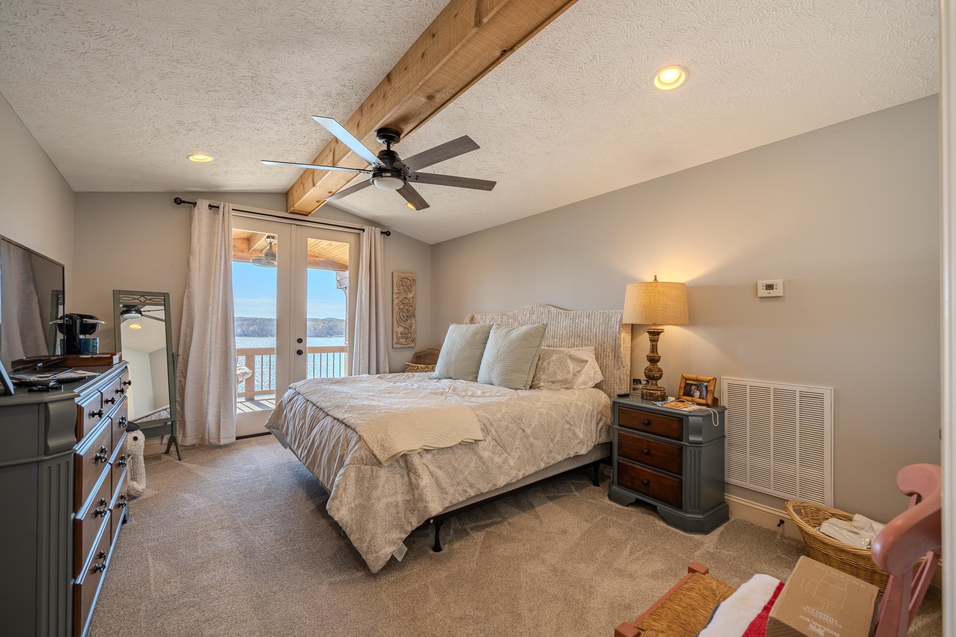 75 C Oasis Lane Savannah, TN 38372 - Photo 19 of 38 a spacious bedroom with a bed a chandelier and a flat screen tv