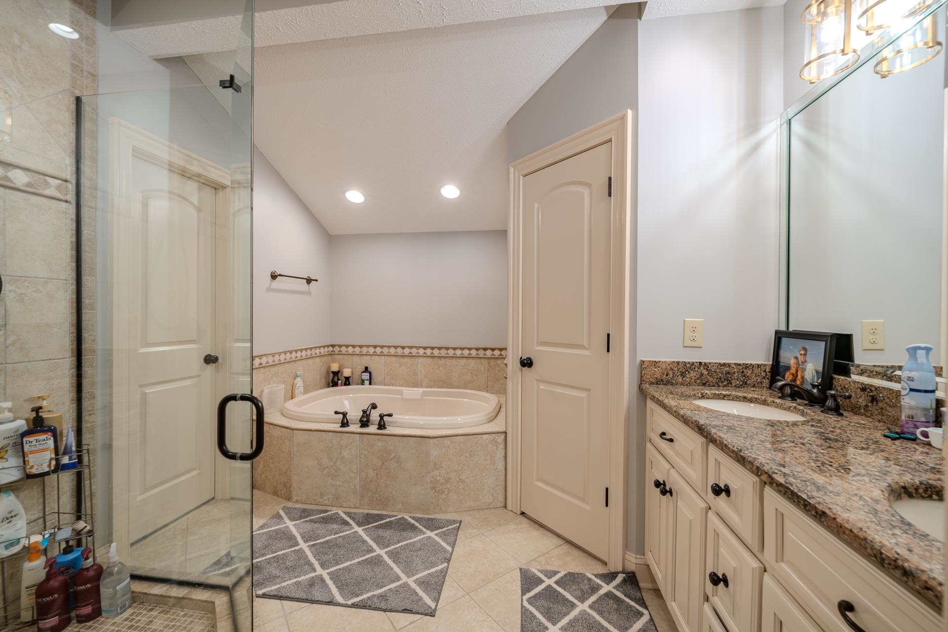 75 C Oasis Lane Savannah, TN 38372 - Photo 20 of 38 a spacious bathroom with a granite countertop sink and a mirror