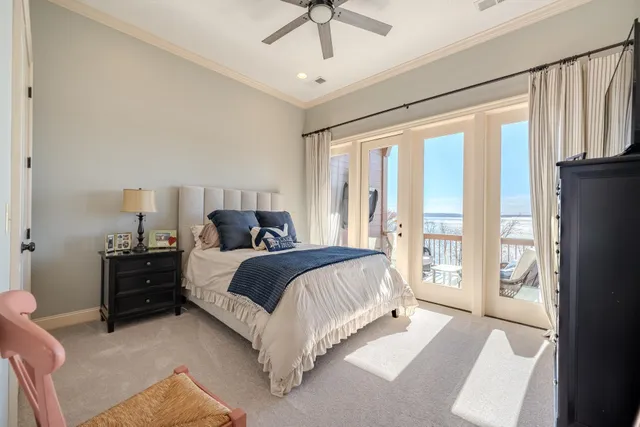 a bedroom with a bed and a flat tv screen on the dresser