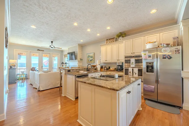 a kitchen with a sink cabinets and wooden floor