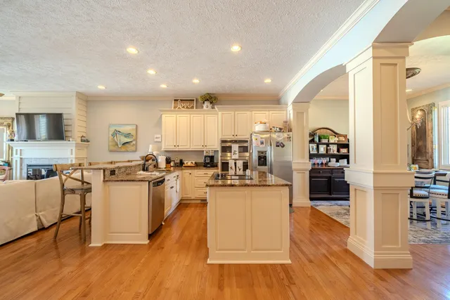 a view of a dining room with furniture and a chandelier