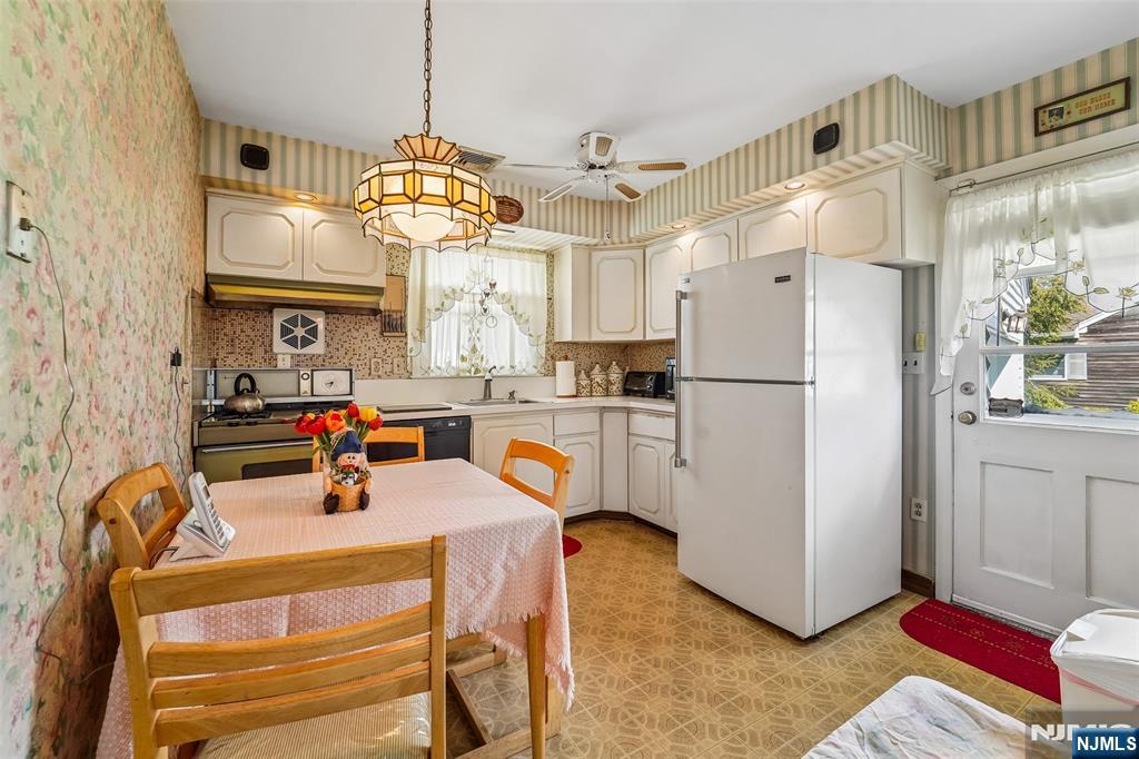 193 Homestead Road Paramus, NJ 07652 - Photo 12 of 33 a kitchen with stainless steel appliances a refrigerator a sink dishwasher a oven with white cabinets and wooden floor