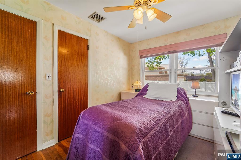 193 Homestead Road Paramus, NJ 07652 - Photo 17 of 33 a bedroom with a bed and a chandelier