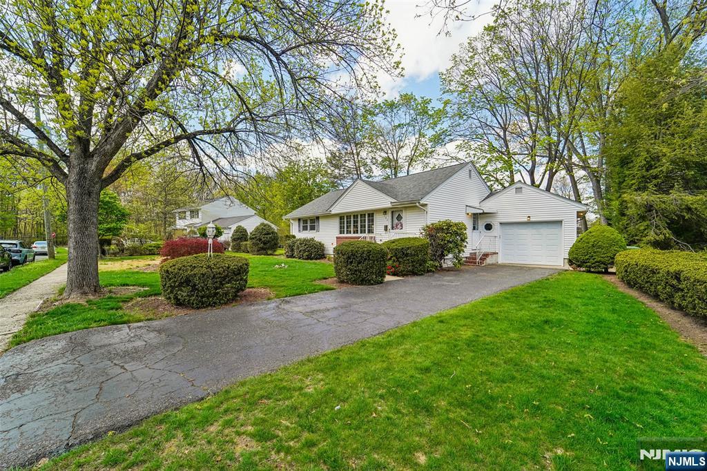 193 Homestead Road Paramus, NJ 07652 - Photo 3 of 33 a front view of a house with garden