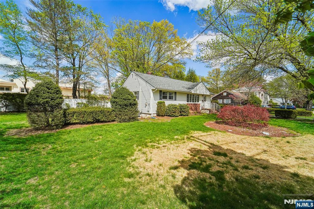 193 Homestead Road Paramus, NJ 07652 - Photo 4 of 33 a view of house in front of a big yard with large trees