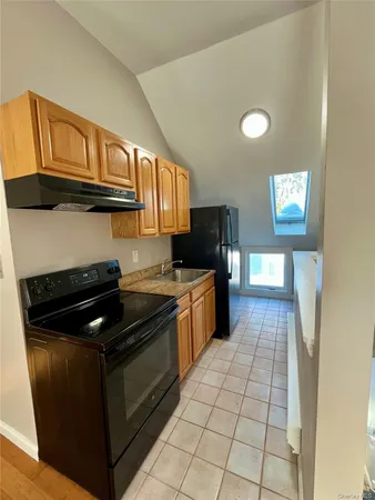 a kitchen with granite countertop stainless steel appliances and wooden cabinets