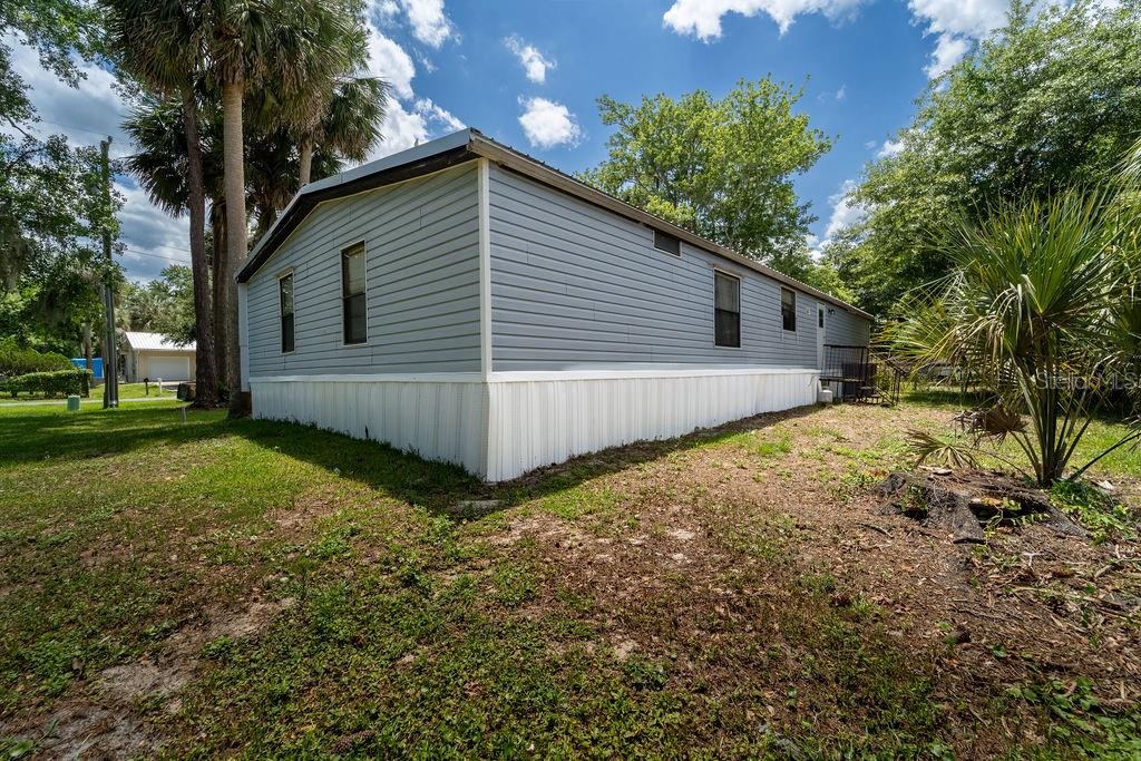 24031 Armadillo Road Astor, FL 32102 - Photo 40 of 43 a view of a backyard with a large tree