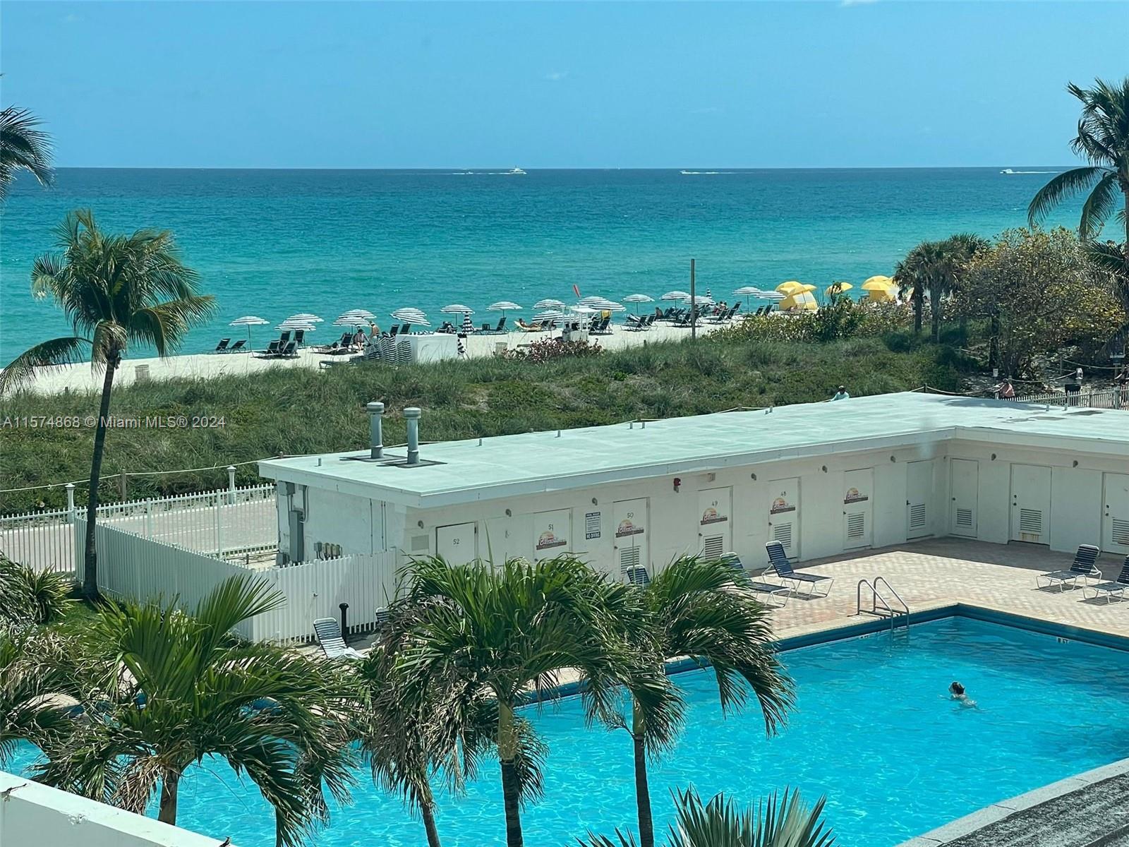 a view of a swimming pool and an outdoor seating
