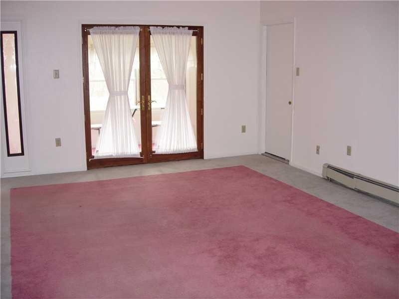 9962 Grubbs Road Wexford, PA 15090 - Photo 4 of 15 Living Room. Large room with french door to atriam. Door on right leads to garage. This room has beamed ceilings and a large front window.