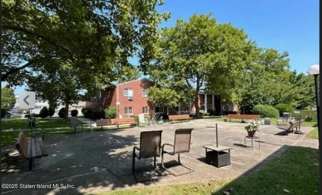 a view of backyard with swimming pool and trees