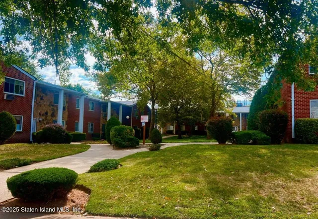 a view of a house with a yard and tree s