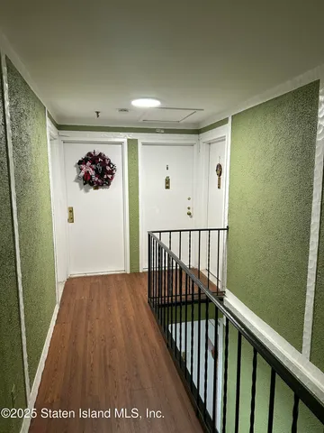 a view of hallway with wooden floor