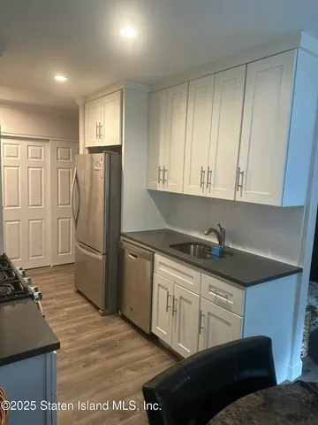 a kitchen with stainless steel appliances granite countertop a refrigerator and a stove