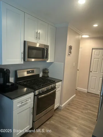 a kitchen with a stove and a microwave