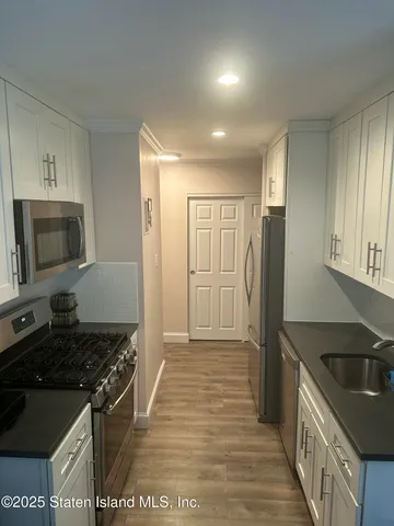 a kitchen with stainless steel appliances granite countertop a stove and a refrigerator
