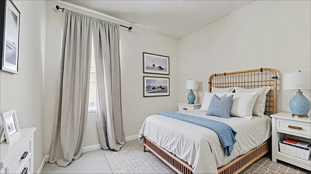 a bedroom with bed and a window