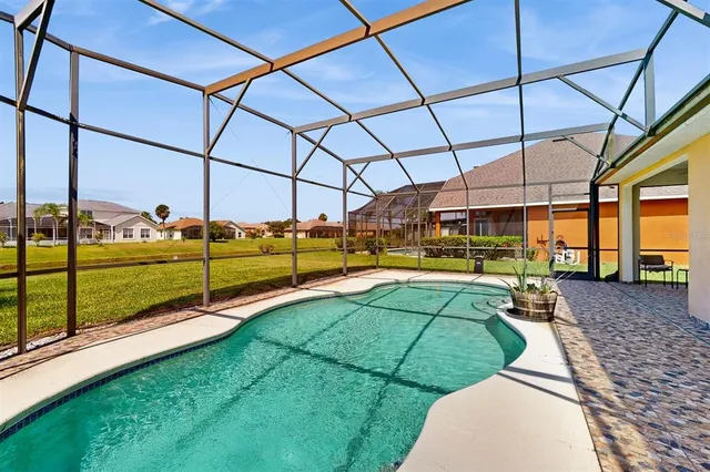 a view of an house with backyard and a tree