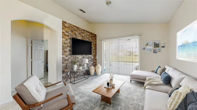 a living room with furniture couches and a flat screen tv