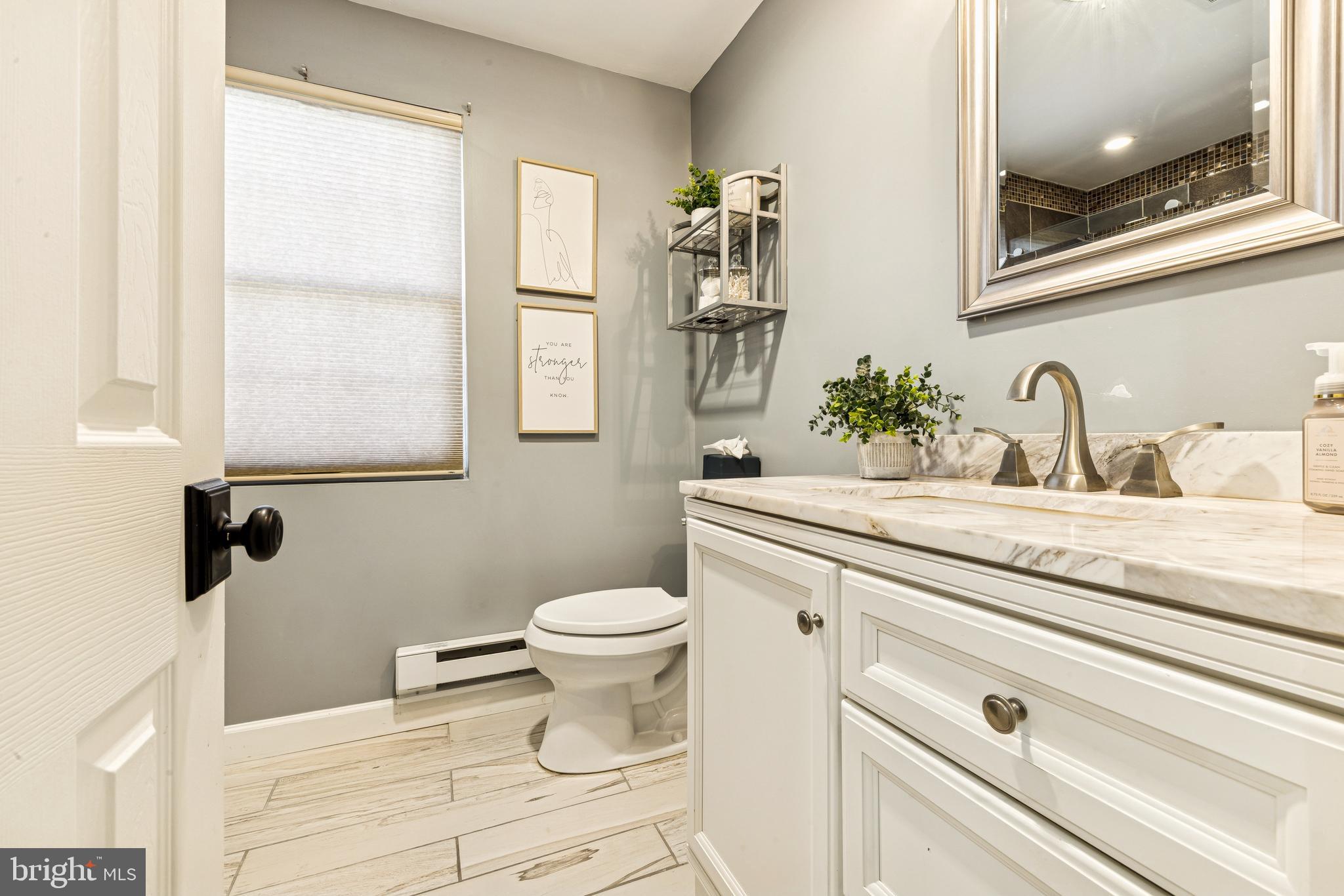 224 Hurffville Grenloch Road Sewell, NJ 08080 - Photo 16 of 23 a bathroom with a granite countertop toilet sink and mirror