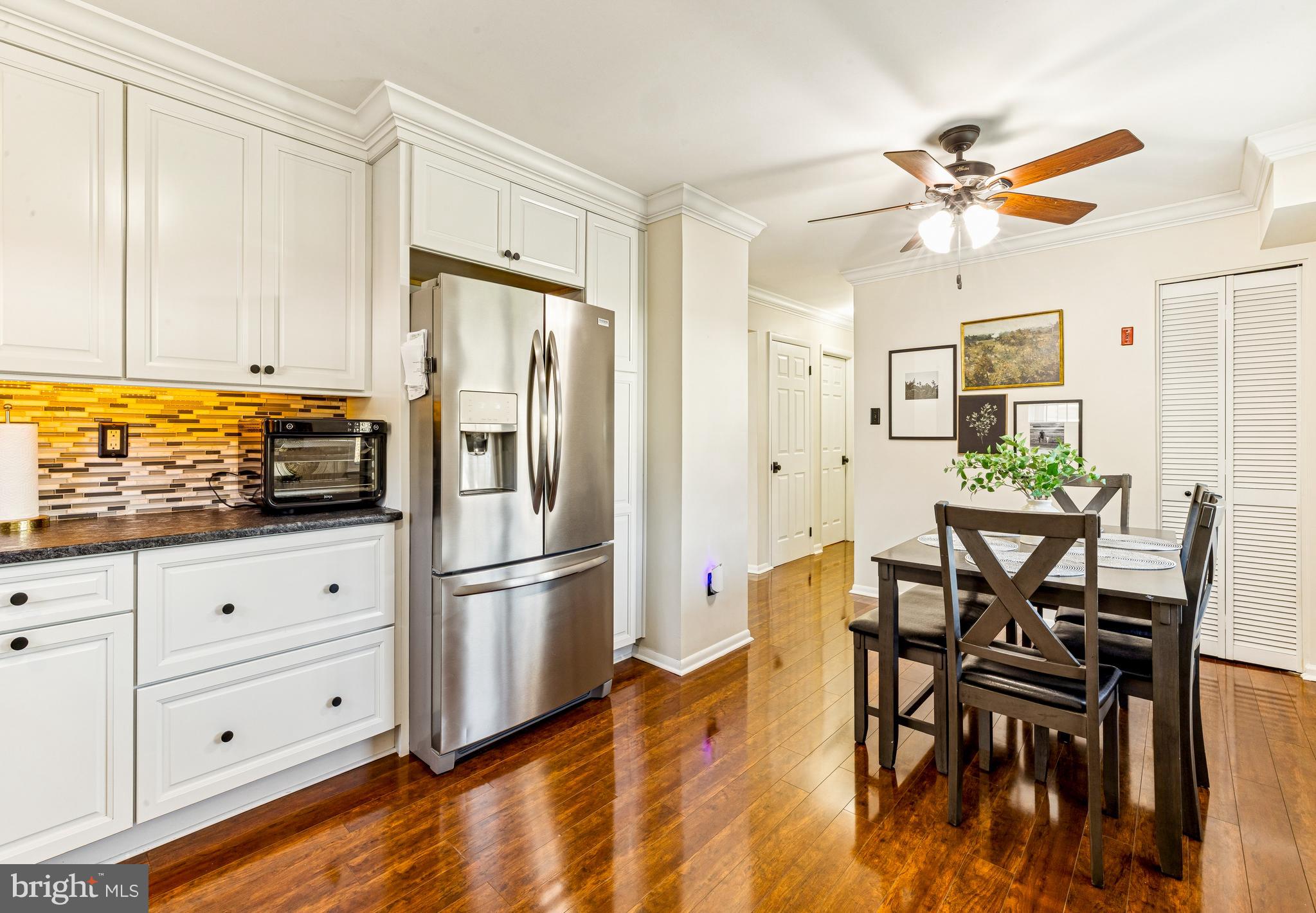 224 Hurffville Grenloch Road Sewell, NJ 08080 - Photo 9 of 23 a kitchen with stainless steel appliances granite countertop a refrigerator a stove a dining table and chairs with wooden floor