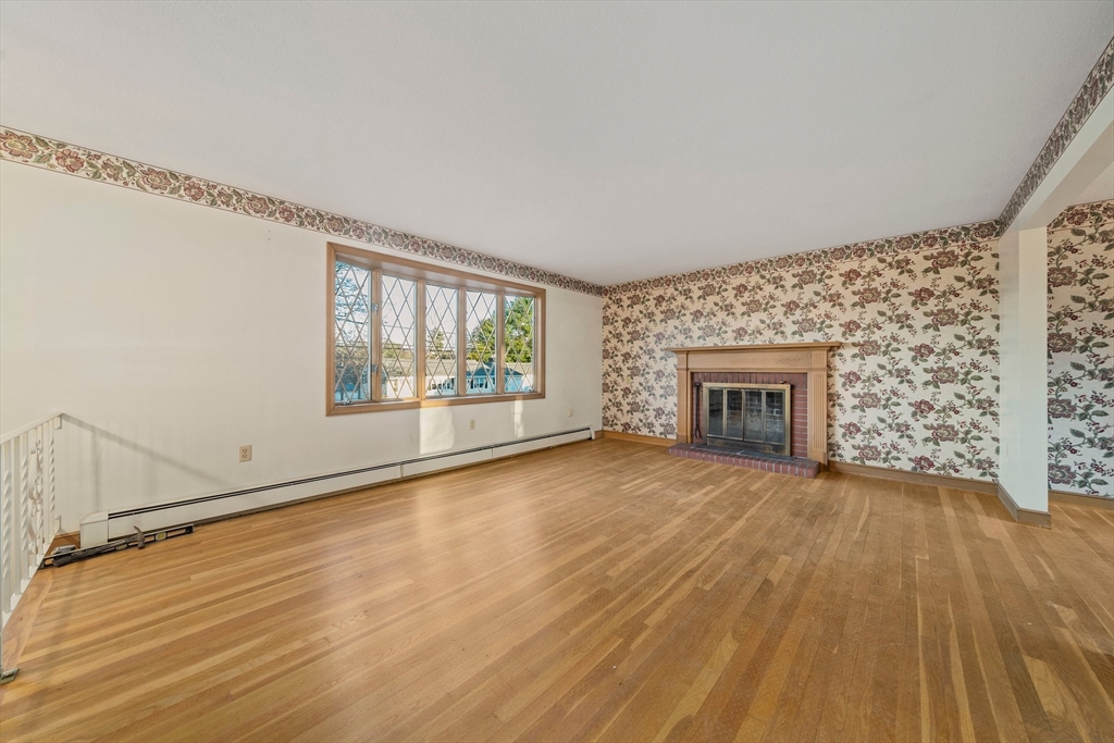 59 Windsor Road Weymouth, MA 02190 - Photo 12 of 39 wooden floor fireplace and windows in an empty room