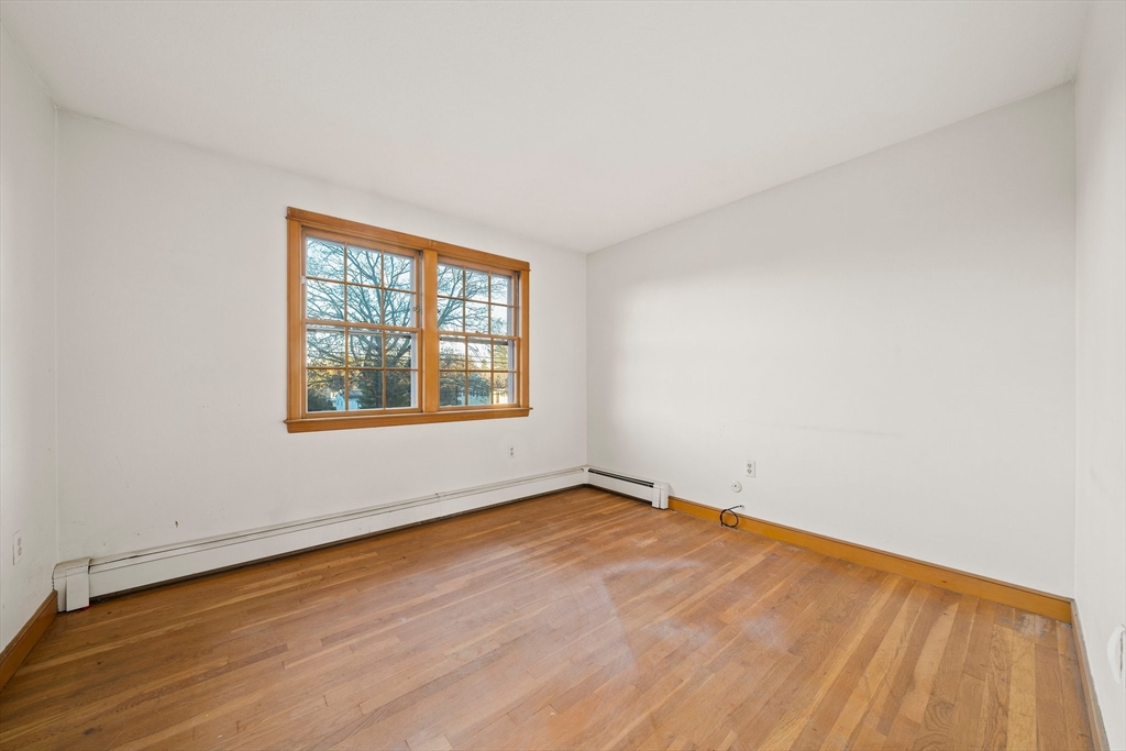 59 Windsor Road Weymouth, MA 02190 - Photo 16 of 39 an empty room with wooden floor and windows