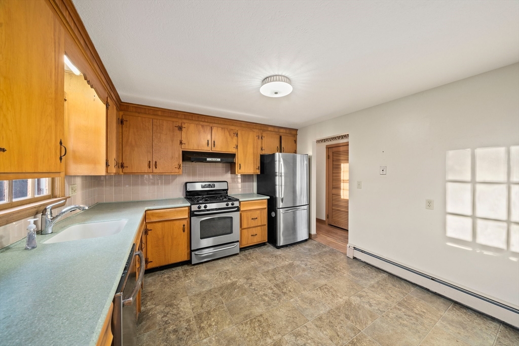 59 Windsor Road Weymouth, MA 02190 - Photo 4 of 39 a kitchen with stainless steel appliances granite countertop a stove a sink dishwasher a refrigerator and a stove with wooden floor