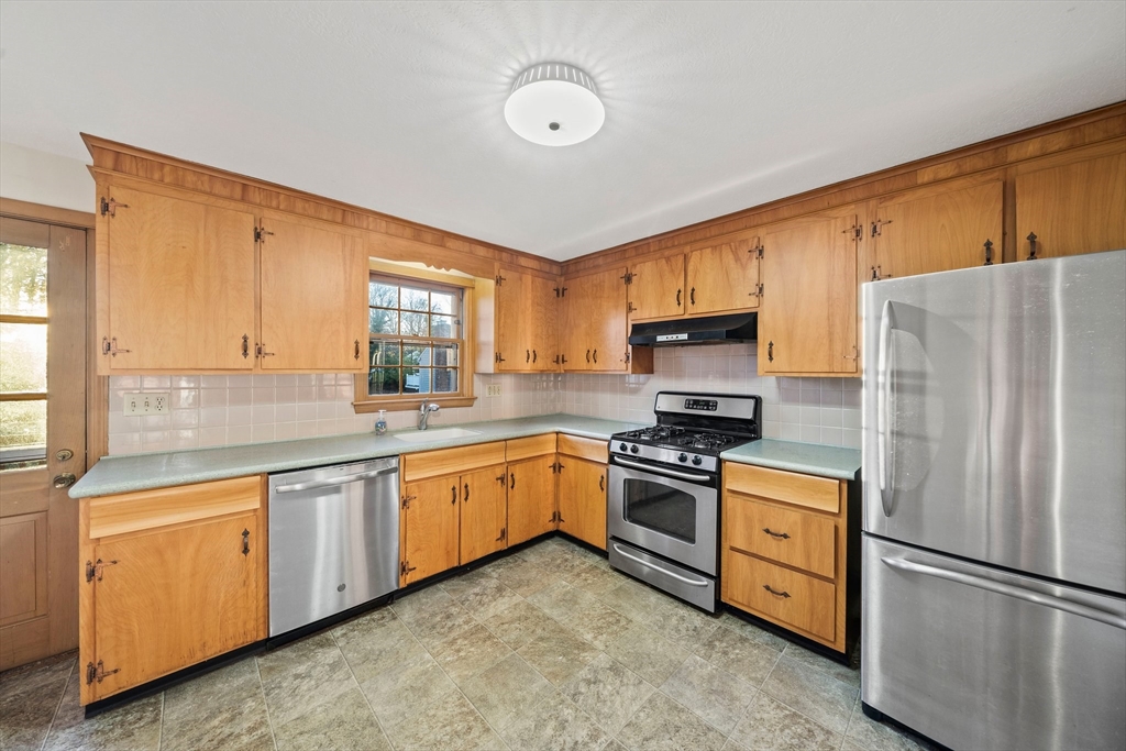 59 Windsor Road Weymouth, MA 02190 - Photo 5 of 39 a kitchen with granite countertop stainless steel appliances a refrigerator stove top oven and sink