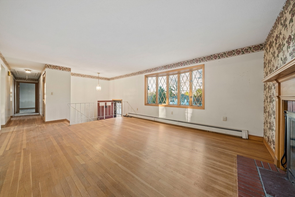 59 Windsor Road Weymouth, MA 02190 - Photo 10 of 39 a view of an empty room with wooden floor and a window