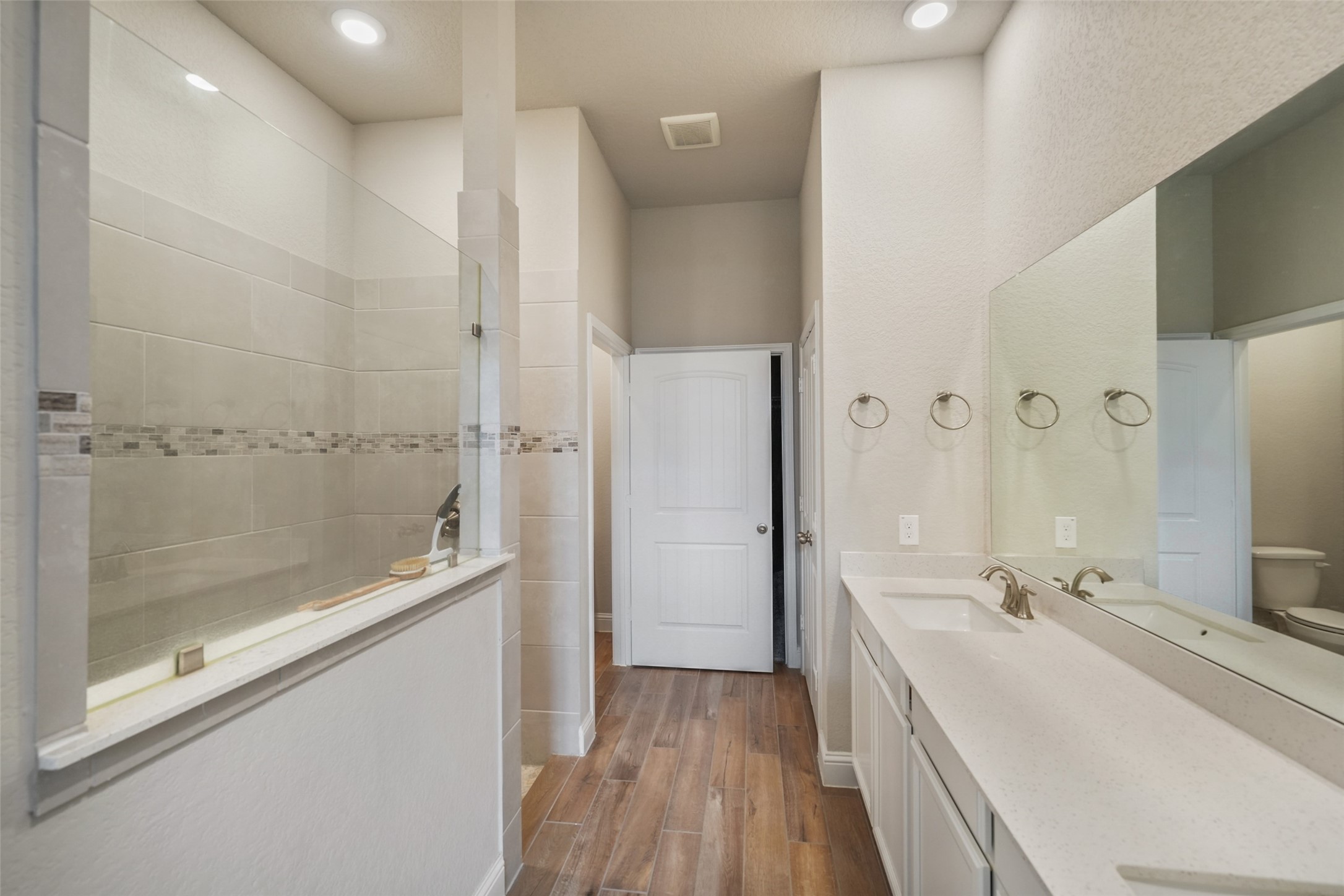 21335 Sierra Point Lane Porter, TX 77365 - Photo 15 of 33 a spacious bathroom with a double vanity sink a mirror and a shower